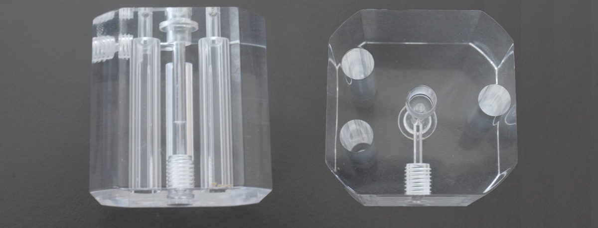 Machined acrylic parts showing cloudy surface and visible machining marks before polishing